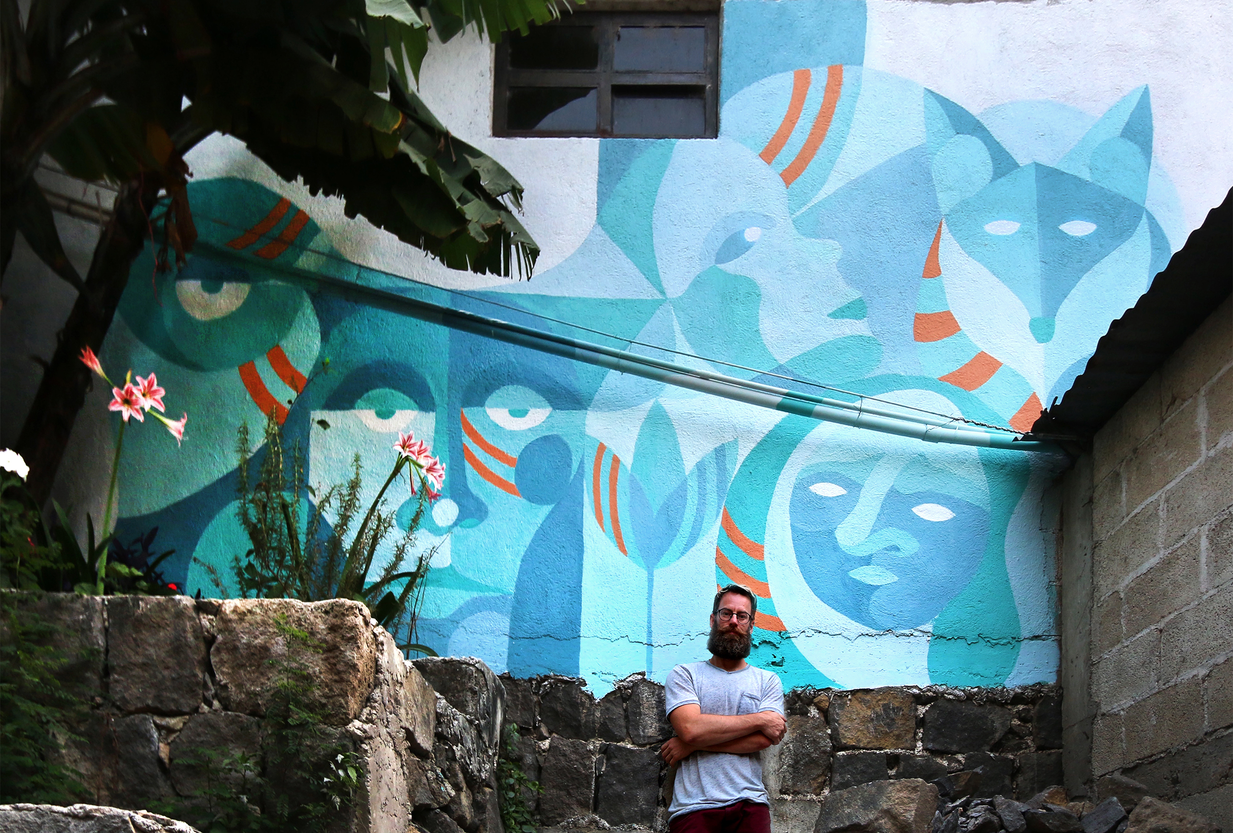 Edmonton-based mural artist, Steven Teeuwsen with his mural painted in Guatemala